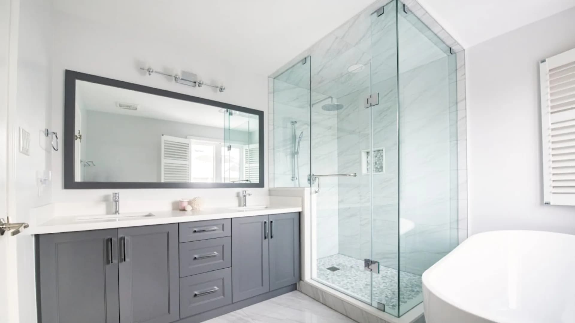 Professional installing a glass shower door in a residential bathroom