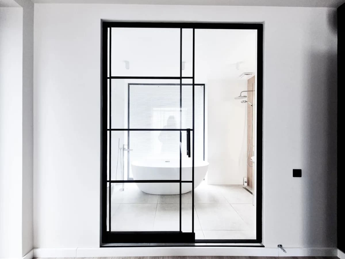 Close-up of a stylish framed shower door installation