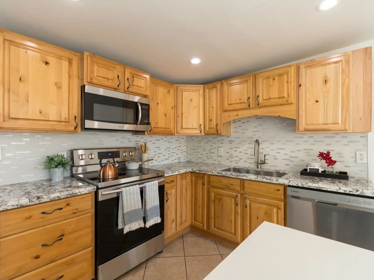 Water-damaged cabinet material around a loose hinge mounting area.