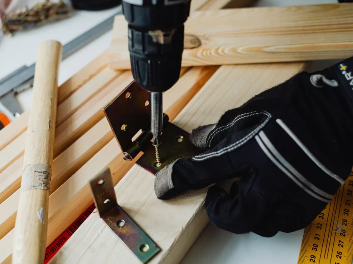 Cabinet pulls, knobs, screws, and a drilling template arranged for installation.