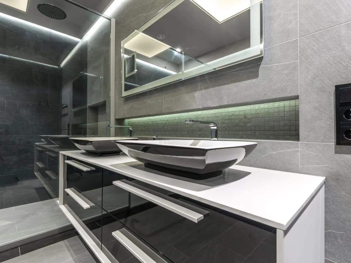 Water-damaged particleboard inside a bathroom vanity beneath a sink.
