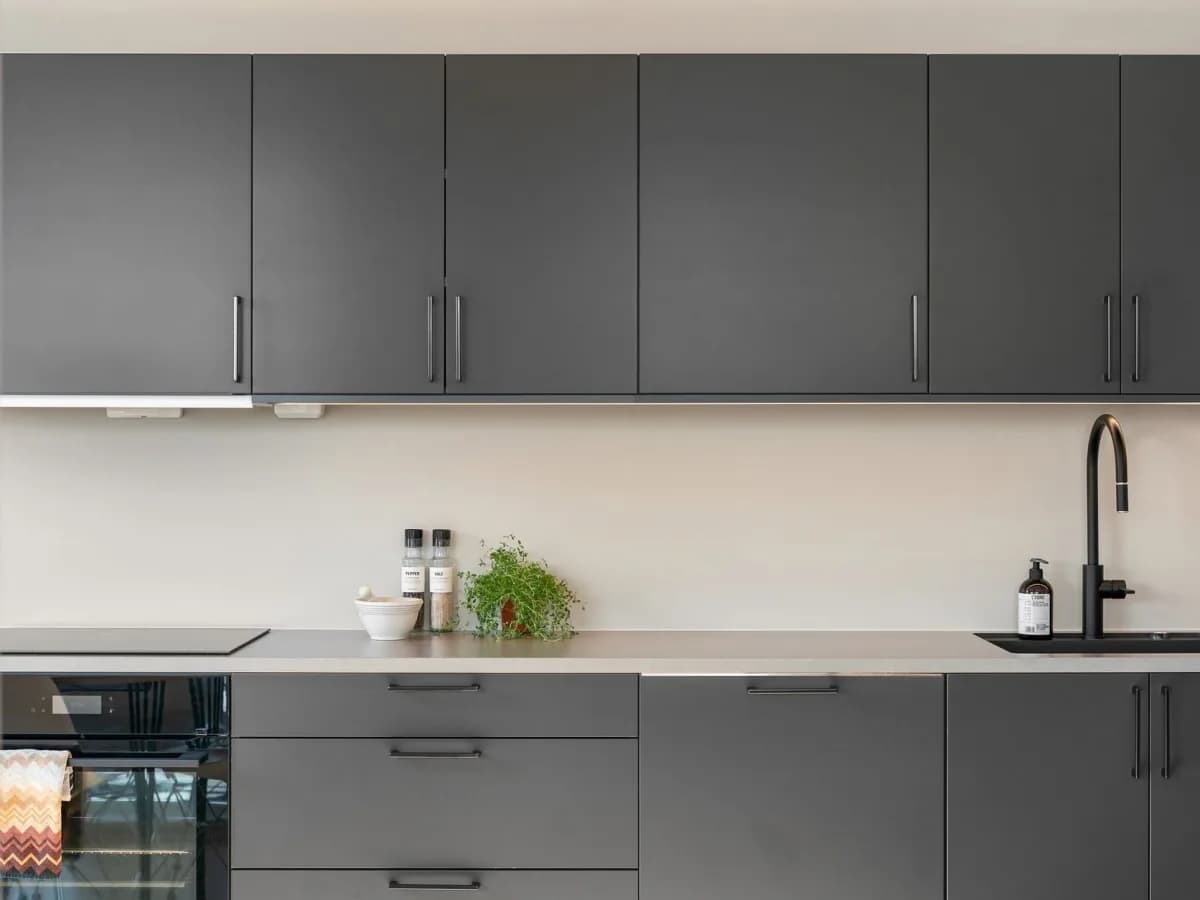 Kitchen cabinets with aligned doors and matching installed handles