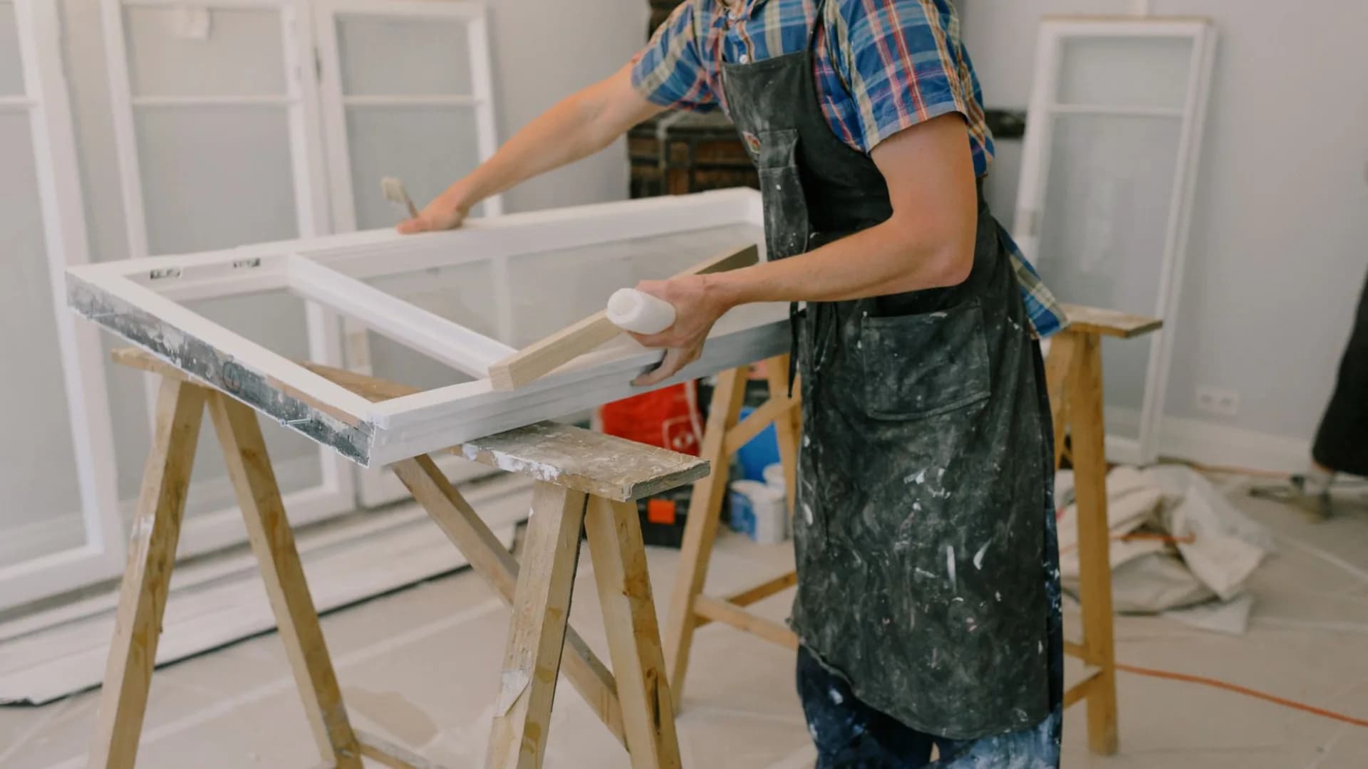 Worker adjusting a concealed hinge on a kitchen cabinet door
