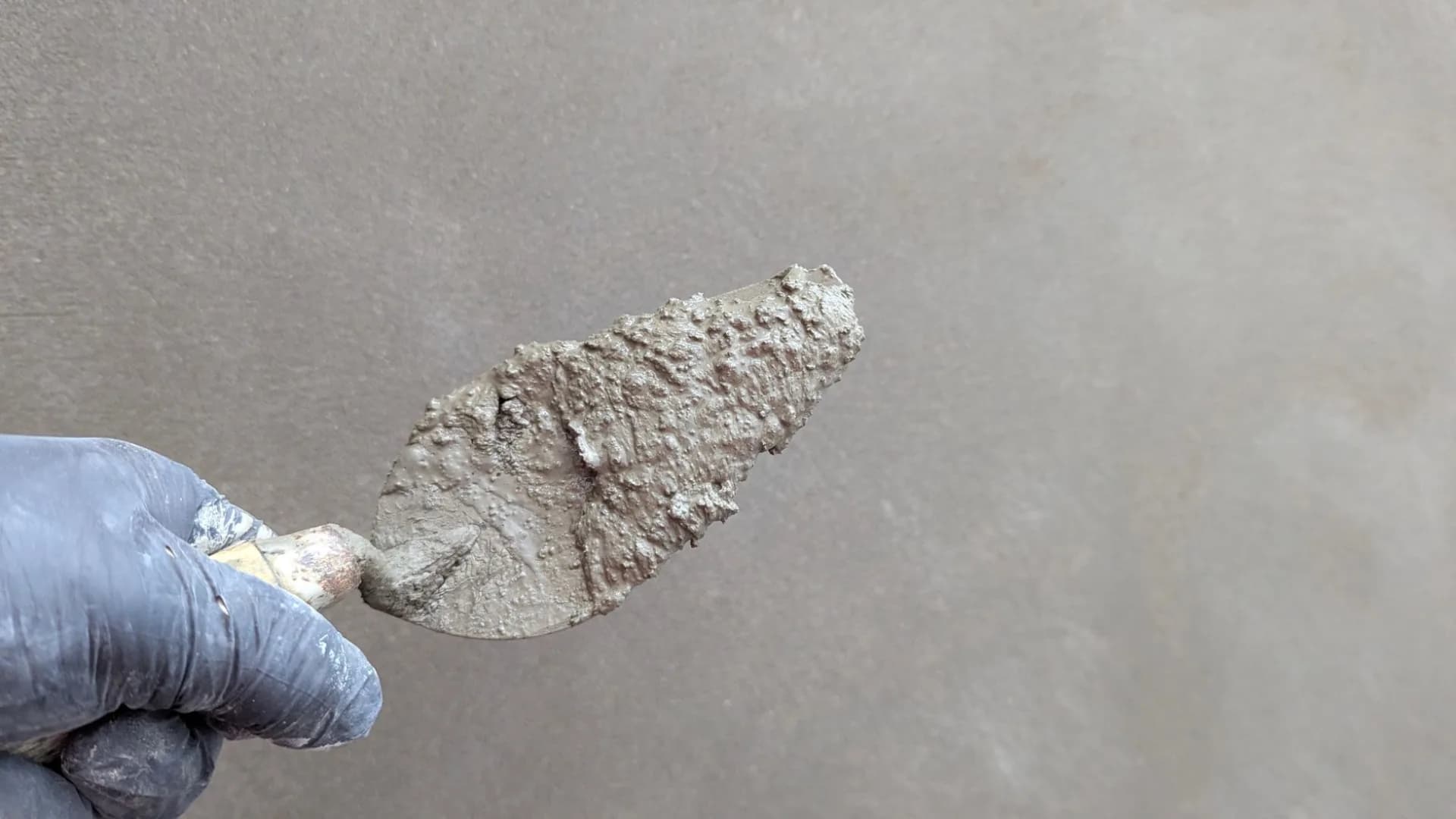 Worker inspecting waterproofing during a residential bathroom renovation