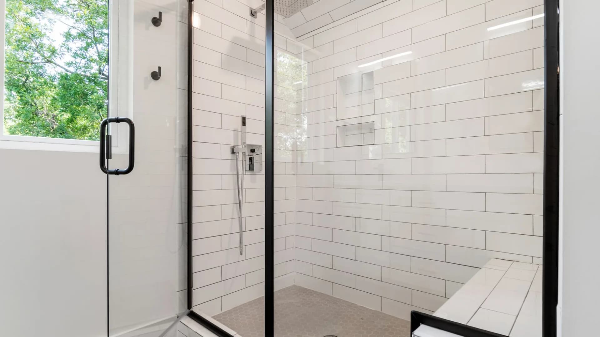 Worker installing wall tile during a residential bathroom renovation