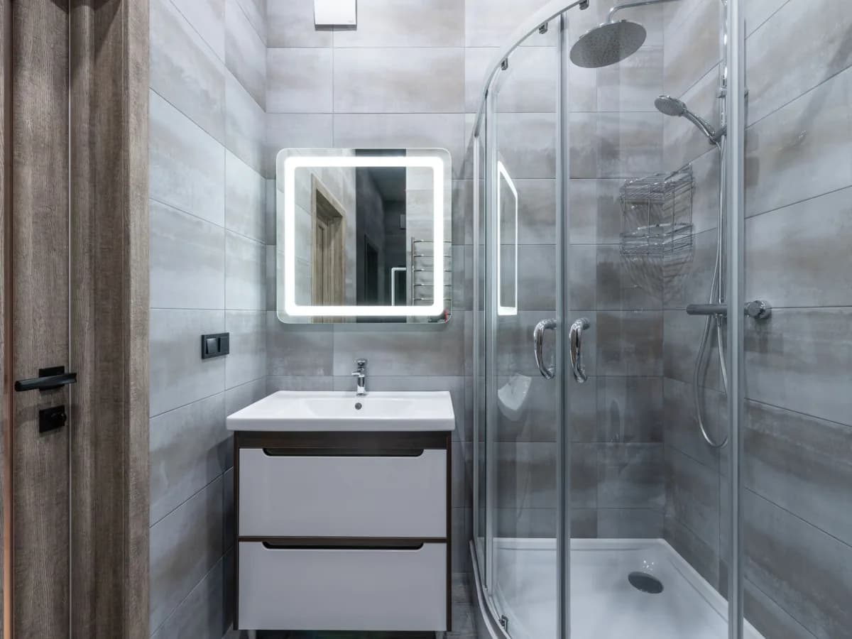 Waterproofed shower walls and drain area prepared for tile installation