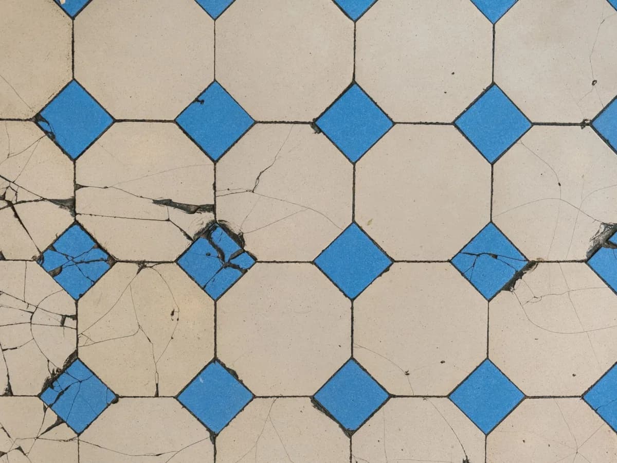 Water damaged kitchen floor with buckled tiles