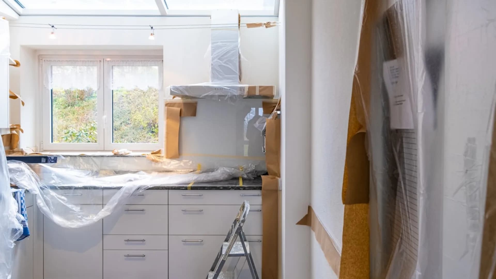 Person painting kitchen cabinets