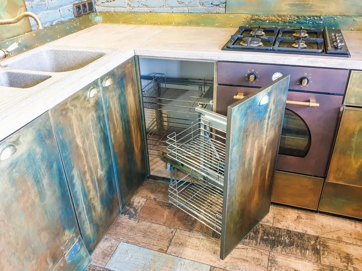 Close-up of worn kitchen cabinets needing renovation.